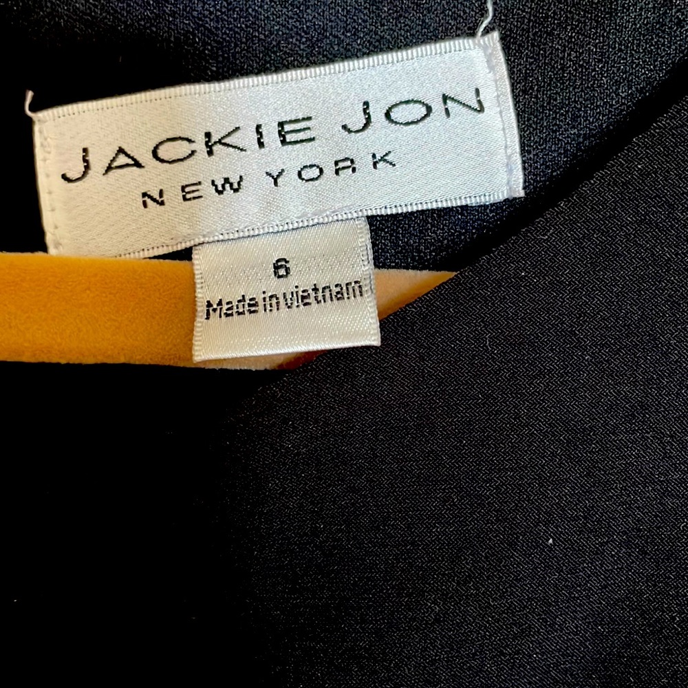 Black cocktail dress. Rhinestone embellishments.  Sheath.